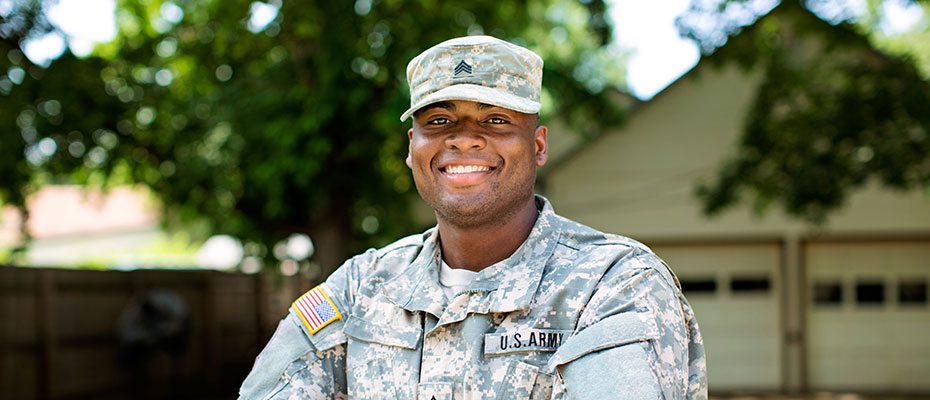US Army soldier in front of his house.